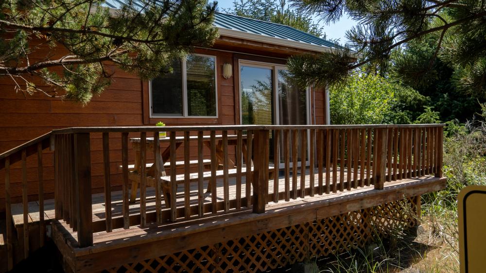 Sun shines on a rustic cabin at Ocean Mist Resort.